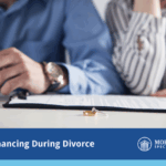refinancing during divorce with an image of a broken up couple with paperwork