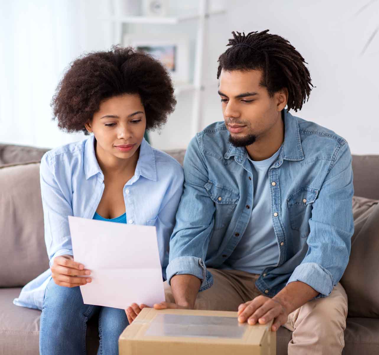 man and woman looking at paper