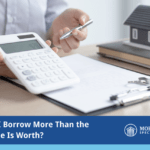 can i borrow more than the house is worth? with an image of a mortgage lender figuring out payment